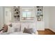 Comfortable white sofa with decorative pillows in a well-lit living room with built-in bookshelves at 3804 Nottaway Rd, Durham, NC 27707