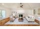 Spacious living room features a vaulted ceiling, fireplace, wood floors, and access to a patio at 3804 Nottaway Rd, Durham, NC 27707