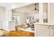 Bright living room with fireplace, wood floors, and access to a patio, offering a comfortable and inviting space at 3804 Nottaway Rd, Durham, NC 27707
