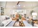 Living room view, with a vaulted ceiling, fireplace, wood floors, and an open-concept design leading into kitchen at 3804 Nottaway Rd, Durham, NC 27707