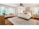 Spacious main bedroom with large windows, a seating area, and hardwood floors at 3804 Nottaway Rd, Durham, NC 27707