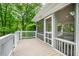 View of the screened porch with seating area from the exterior deck at 3804 Nottaway Rd, Durham, NC 27707