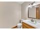 Well-lit half bathroom featuring a wood vanity and a classic design at 3909 Inland Ct, Raleigh, NC 27606