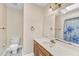 Well-lit bathroom with a single vanity and shower with blue floral shower curtain at 3909 Inland Ct, Raleigh, NC 27606