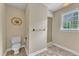 Bright bathroom featuring a toilet, shower, and neutral walls and floor at 3909 Inland Ct, Raleigh, NC 27606