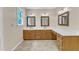 Bathroom featuring double sinks, wood cabinets, a vanity, and tile floors at 3909 Inland Ct, Raleigh, NC 27606