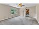 Bright bedroom with window, neutral paint and carpet, and a ceiling fan at 3909 Inland Ct, Raleigh, NC 27606