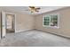 Bright bedroom with window, neutral paint and carpet, and a ceiling fan at 3909 Inland Ct, Raleigh, NC 27606