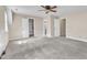 Bright bedroom with ceiling fan, neutral carpet and paint, and a large closet at 3909 Inland Ct, Raleigh, NC 27606