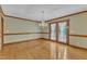 Dining room featuring hardwood floors, chandelier, and glass paneled doors leading outside at 3909 Inland Ct, Raleigh, NC 27606