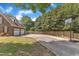Long driveway leading to brick two-story home with two-car garage and basketball hoop at 3909 Inland Ct, Raleigh, NC 27606