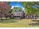 Charming brick home featuring a covered porch, dormer windows, and a well-maintained lawn at 3909 Inland Ct, Raleigh, NC 27606