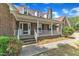 Inviting front porch with white railings and brick accents leads to the main entrance at 3909 Inland Ct, Raleigh, NC 27606