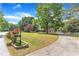 Beautiful home with a well-manicured lawn, mature trees, and a long driveway at 3909 Inland Ct, Raleigh, NC 27606