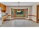 Eat-in kitchen area with large bay window offering backyard view and stainless steel refrigerator at 3909 Inland Ct, Raleigh, NC 27606
