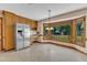 Eat-in kitchen area with large bay window offering backyard view and stainless steel refrigerator at 3909 Inland Ct, Raleigh, NC 27606