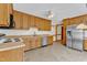 Kitchen featuring wood cabinets, stainless steel appliances, and tile floors at 3909 Inland Ct, Raleigh, NC 27606