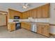 Kitchen featuring tile floors, wood cabinets, and stainless steel appliances at 3909 Inland Ct, Raleigh, NC 27606