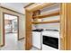 Convenient laundry room with modern washer and dryer, storage shelves, and access to the backyard at 3909 Inland Ct, Raleigh, NC 27606
