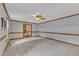 Spacious living room with neutral carpet, ceiling fan, and wooden trim at 3909 Inland Ct, Raleigh, NC 27606