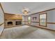 Spacious living room with a brick fireplace and mantel plus two windows with outdoor views at 3909 Inland Ct, Raleigh, NC 27606