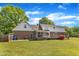 Charming brick and vinyl two-story home with a spacious, well-manicured backyard at 3909 Inland Ct, Raleigh, NC 27606