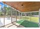 Relaxing screened porch with wood ceiling providing an unobstructed view of the backyard at 3909 Inland Ct, Raleigh, NC 27606
