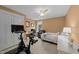 Bedroom with a ceiling fan, desk, and home exercise equipment, offering a functional space at 408 Jerome Rd, Durham, NC 27713