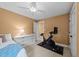 Inviting bedroom with a ceiling fan, white dresser, and Peloton bike, creating a space for relaxation and fitness at 408 Jerome Rd, Durham, NC 27713