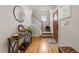Bright foyer featuring hardwood floors, staircase, and a charming wooden front door at 408 Jerome Rd, Durham, NC 27713
