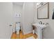 Charming half bathroom featuring a pedestal sink, stylish fixtures, and neutral decor at 408 Jerome Rd, Durham, NC 27713
