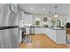 Modern kitchen with white cabinets, stainless steel appliances, and a view to the backyard at 408 Jerome Rd, Durham, NC 27713