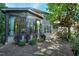 View of home with sunroom surrounded by backyard foliage at 419 Travertine Dr, Cary, NC 27519
