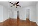 This bedroom has gleaming hardwood floors and a ceiling fan, with multiple entry ways at 419 Travertine Dr, Cary, NC 27519