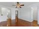 Bedroom features include hardwood floors, a ceiling fan, and doorways leading to other rooms at 419 Travertine Dr, Cary, NC 27519