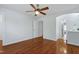 Hardwood floors, a ceiling fan, and an ensuite bathroom entrance enhance this bright bedroom at 419 Travertine Dr, Cary, NC 27519
