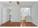 Spacious bedroom with gleaming hardwood floors and a partial view of an en suite bathroom at 419 Travertine Dr, Cary, NC 27519