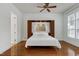 Cozy bedroom with hardwood floors, a ceiling fan, and built-in shelving around the headboard at 419 Travertine Dr, Cary, NC 27519
