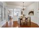 Dining room with hardwood floors, a chandelier, and an open view to the kitchen at 419 Travertine Dr, Cary, NC 27519