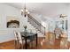 Bright dining room with hardwood floors, wainscoting, chandelier, and staircase at 419 Travertine Dr, Cary, NC 27519
