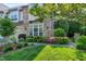 Beautiful exterior of a home featuring lush landscaping, a stone facade, and a well-manicured lawn at 419 Travertine Dr, Cary, NC 27519
