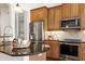 Kitchen featuring stainless appliances, granite counters, custom cabinets, and breakfast bar at 419 Travertine Dr, Cary, NC 27519