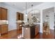 Kitchen with custom cabinets, granite countertops, stainless appliances, and central island with seating at 419 Travertine Dr, Cary, NC 27519