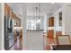 Open kitchen featuring stainless steel appliances, custom cabinets, granite countertops, and island seating at 419 Travertine Dr, Cary, NC 27519