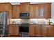 Close-up of kitchen features including granite countertops, stainless steel appliances, and custom cabinetry at 419 Travertine Dr, Cary, NC 27519
