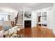 Stylish living room featuring hardwood floors, a fireplace, and an open layout to the dining area at 419 Travertine Dr, Cary, NC 27519