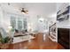 Inviting living area with hardwood floors, a ceiling fan, and natural light from multiple windows at 419 Travertine Dr, Cary, NC 27519