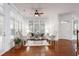Bright living room with large windows, hardwood floors, and a cozy seating area at 419 Travertine Dr, Cary, NC 27519