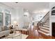 Open-concept living area with hardwood floors, flowing seamlessly into the dining and kitchen spaces at 419 Travertine Dr, Cary, NC 27519