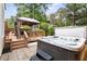 Relax on the covered deck or soak in the hot tub in this fully fenced backyard at 4704 Lancashire Dr, Raleigh, NC 27613